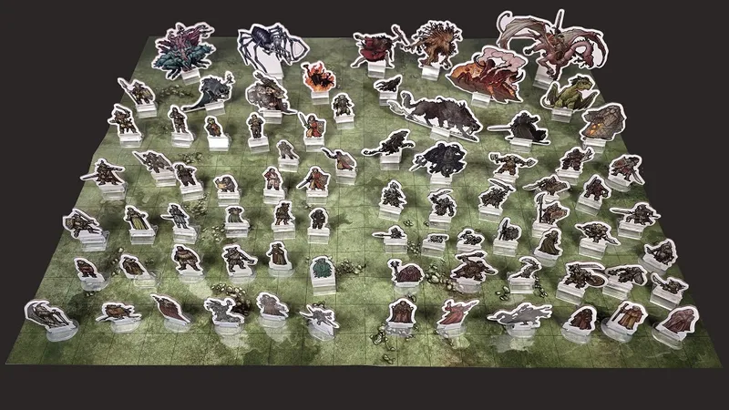 Cardboard standees of fantasy characters and creatures on a green grid map.
