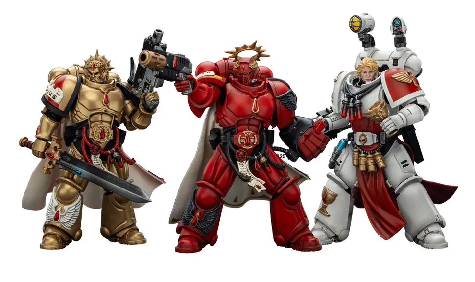 Three action figures representing Blood Angels Space Marines stand side by side. The first figure on the left is clad in red armor, holding a gun, and features intricate detailing. The central figure, also in red, has a prominent golden halo and a cape, while the figure on the right wears white armor with red accents and is equipped with various accessories, including a holstered weapon and a mechanical arm.
