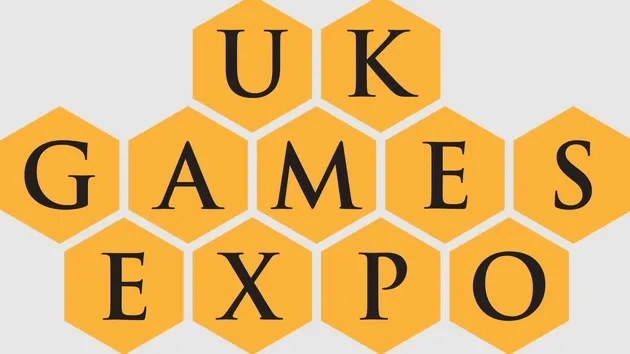 The design features the text "UK GAMES EXPO" arranged in a honeycomb pattern, with each letter placed inside a yellow hexagon. The font is bold and black, creating a strong contrast against the yellow background. The overall layout emphasizes the event's branding in a visually engaging manner.