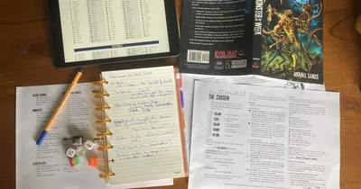 Topdown photo of a solo game in progress. Roll table from Mythic on tablet, Monster of the Week rulebook, journal for note taking, reference sheets