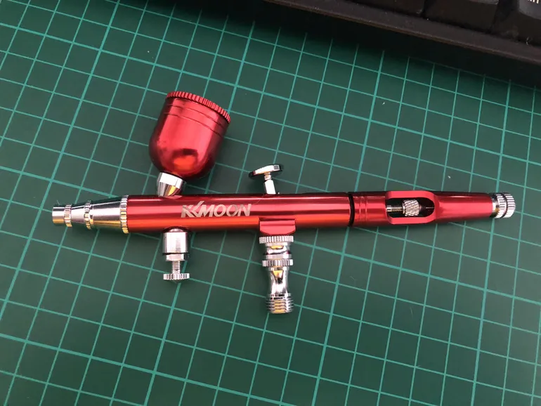 kkmoon airbrush in anodised red on a cutting mat