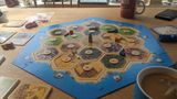 The Catan board laid out as  advised for beginners. On a dining table with tea