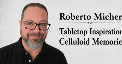 Man with glasses and beard, text: "Roberto M Tabletop In Celluloid M"