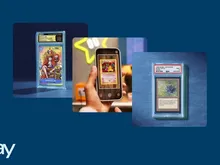 Graded trading card in a case, hand holding phone scanning a Pokémon card, eBay logo.