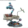 A painted miniature of a large, colorful, humanoid figure with a rounded head and body, standing on a ruined brick wall base. The figure has a long, thin arm extending upward, holding a green street sign labeled "Main St" and "75th Street". The base includes broken bricks and debris. The background is plain white. Text at the top reads "MINIATURES ARE SUPPLIED UNASSEMBLED AND UNPAINTED". In the bottom right corner, text reads "©2025 MARVEL © AMG".