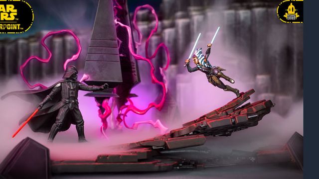 The image features a dynamic scene from the Star Wars: Shatterpoint game, showcasing miniatures of Ahsoka Tano and Darth Vader engaged in a duel. Ahsoka, wielding two lightsabers, is positioned in an action pose, while Darth Vader stands menacingly with his red lightsaber drawn. The backdrop includes a detailed scenic terrain piece resembling a Sith temple, with swirling purple energy and mist adding to the dramatic atmosphere of their confrontation.