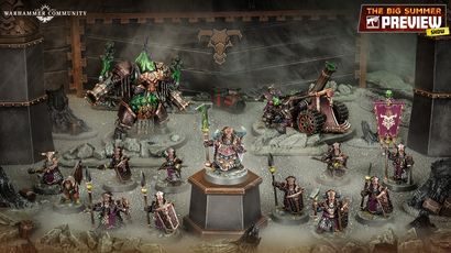 A detailed display of the new Zharrdron army features various miniatures set against a dark, industrial backdrop. In the center, a prominent War Despot stands on a pedestal, clad in imposing armor and wielding a staff, surrounded by Infernal Cohorts holding spears. To the left, a large, menacing Dominator Engine looms, while a mortar-like Tormentor Bombard is positioned on the right, showcasing the army's dark and chaotic aesthetic.