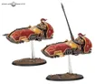 Two red and gold jetbikes with riders on bases.