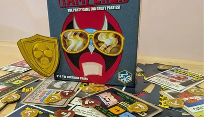Crime Scene Tamperer game box with cards and tokens scattered on a wooden floor.