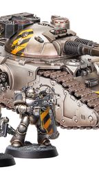 A detailed image features a large, imposing Fellblade super-heavy tank, showcasing a metallic finish with yellow hazard stripes on its turret. Flanking the tank are two MkII Assault Marines, one wielding an axe and the other holding a bolter, both adorned in similar black and yellow armor. The base of the miniatures is textured, enhancing the overall presentation of this Warhammer 40,000 scene.