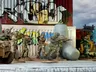 Five toy soldiers in camouflage aim rifles behind a graffiti wall.