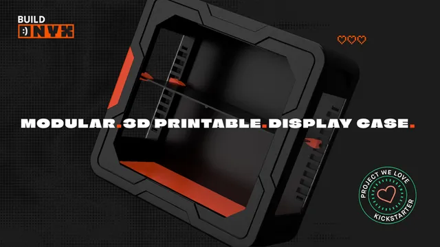 A sleek, 3D-printable display case designed for collectors, featuring a black exterior with angular lines and a vibrant red base. The case is shown from a slightly elevated angle, highlighting its modular design and snap-fit assembly, which requires no tools. The text "3D-PRINTABLE. DISPLAY CASE." is prominently displayed, along with a "PROJECT WE LOVE" badge from Kickstarter.