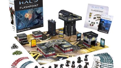 A boxed set for Halo: Flashpoint titled "Feet First into Hell" is prominently displayed, featuring artwork of soldiers in combat. Surrounding the box are 18 detailed miniatures of Orbital Drop Shock Troopers, along with a play mat depicting an urban warzone, several buildings, and various game components including dice, tokens, and cards. The scene is organized, showcasing the miniatures in a dynamic layout, emphasizing the tactical elements of the game.