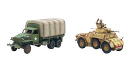 A green and brown camouflaged American Studebaker truck is positioned on the left, featuring a covered cargo area and a white star insignia on its side. Next to it, on the right, is a tan Autoblinda AB41 armored car, showcasing a rounded body and a turret, with a slightly weathered appearance. Both vehicles are detailed models suitable for tabletop gaming, reflecting their historical designs from WWII.