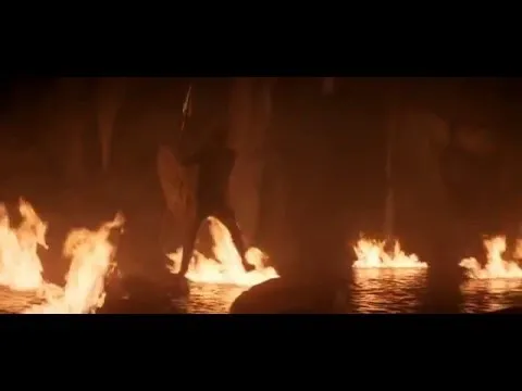 Fires burning on dark water at night