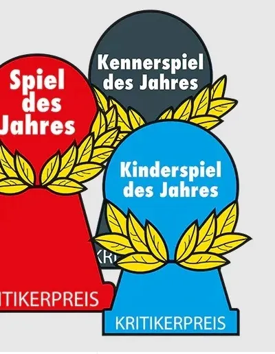 Three pawn-shaped awards with laurel wreaths. The red award reads "Spiel des Jahres" and "KRITIKERPREIS". The dark gray award reads "Kennerspiel des Jahres". The blue award reads "Kinderspiel des Jahres" and "KRITIKERPREIS".