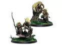 A pair of intricately detailed miniatures from Corvus Belli, featuring a character with long, wild hair wielding a spear, accompanied by a large, stylized creature resembling a lion with a mane of flames. The figures are set on a base adorned with lush green grass and a gnarled tree, enhancing the naturalistic theme. The character appears to be in a dynamic pose, suggesting action or readiness, while the creature stands alert beside them.