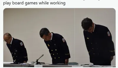 Three firefighters in uniform are bowing their heads in a formal setting, likely during a press conference or disciplinary meeting. The two on the left are wearing dark blue uniforms with badges, while the one on the right has a slightly different posture, suggesting a moment of reflection or apology. The background is neutral, focusing attention on the individuals and their solemn demeanor.