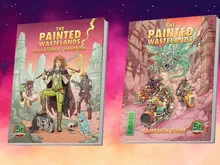 Two books titled The Painted Wastelands: left cover shows a central female character with a staff, surrounded by desert ruins, a cat, and two other figures; text reads "Adventurer’s Handbook." Right cover depicts a fantasy creature atop ruins with a green-tinted desert; text reads "Campaign Guide."