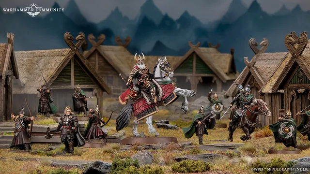A detailed scene features Helm Hammerhand, King of Rohan, depicted both mounted on an armoured horse and on foot, alongside several Rohirrim warriors. The figures are intricately painted, showcasing vibrant colors and detailed armor, set against a backdrop of rustic wooden structures resembling Rohan architecture. The environment includes rocky terrain and hints of mountainous scenery, enhancing the thematic setting of the Middle-earth Strategy Battle Game.