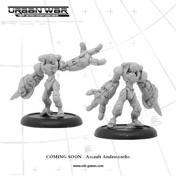 Two miniature figures of Assault Androsynths are displayed, showcasing a futuristic design with mechanical limbs and a humanoid form. One figure stands in a dynamic pose with an outstretched arm, while the other is slightly turned, highlighting its detailed features. The background includes a grid pattern, and the text "COMING SOON - Assault Androsynths" is prominently featured at the bottom.
