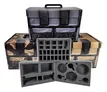 Open hard-shell case with a camouflage pattern exterior. The case has a black handle on top and two black latches on the front. Inside, the lid features a mesh pocket with a zipper and two elastic loops. Below the lid, the base of the case contains customizable gray foam inserts. The top layer of foam has cutouts in various shapes and sizes, including rectangular slots, circular recesses, and smaller circular holes. The middle foam layer has rectangular compartments arranged in rows. The bottom foam layer has larger rectangular cutouts. No text is visible.