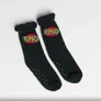 Black socks with "UNO" logo, ruffled tops, and grips on soles.