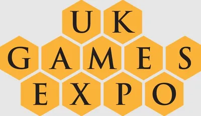 The design features the text "UK GAMES EXPO" arranged in a honeycomb pattern, with each letter placed inside a yellow hexagon. The font is bold and black, creating a strong contrast against the yellow background. The overall layout emphasizes the event's branding in a visually engaging manner.