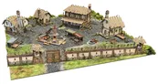 A detailed tabletop terrain scene depicting the Ingonsburn Township, featuring a cobblestone market square surrounded by various buildings, including a large inn, a foundry, and cottages, all enclosed by a secure boundary wall. The buildings have textured roofs and are adorned with furniture, while a central well or forge adds to the bustling atmosphere. Lush green grass peeks through the cobblestones, enhancing the vibrant fantasy setting.