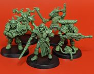 A group of five 28mm scale sci-fi miniatures is displayed against a bright red background. The figures include a Space Commando wielding a rifle, a Starchild with a distinctive helmet, an Assault Goar holding a sword, a Space Orc with a large gun, and a Voidborn equipped with various gadgets. Each miniature features intricate details and a classic old-school aesthetic, showcasing the unique character and charm of the RT Adventurer Pack II from Satyr Art Studios.