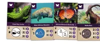 Four game cards: green gecko, West African Manatee with symbol 1 # triangle, numbers 2:3 and 3:7. African Monarch Butterfly with symbol # 1, two interconnected loops, and numbers 2:2. Cards show animal images, symbols, and numeric ratios.