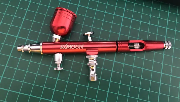 kkmoon airbrush in anodised red on a cutting mat