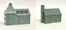 A detailed model of a building designed for 6mm scale wargames, featuring a sloped roof with three dormer windows and a textured surface that resembles slate. The facade includes several arched and rectangular windows, along with a large door at the base, all rendered in a light gray resin. The overall design suggests an industrial style, suitable for various historical or modern warfare settings.