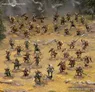Miniature warriors in armor and cloaks on round bases, posed with swords, bows, and spears in a grassy forest setting.