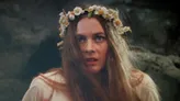 Woman with long blonde hair wearing a white and yellow flower crown.