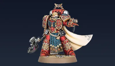 Aster Crohne, a new miniature from Games Workshop, is depicted as a Blood Angels veteran. He wears ornate red armor adorned with gold details and intricate patterns, complemented by a flowing white cape. In one hand, he wields a large, menacing weapon, while his other hand is outstretched, suggesting a commanding presence. The base features a sandy texture, enhancing the overall dynamic of the figure against a dark background.