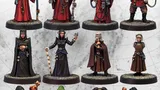 12 painted sci-fi miniatures in 3 rows, various robes and weapons.