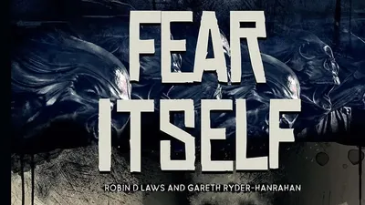 Dark, shadowy figure in hooded coat stands near a cracked wall. A skull with glowing eyes looms in the background. Text reads: "FEAR ITSELF" in bold white letters, with smaller text below: "ROBIN D LAWS AND GARETH RYDER-HANRAHAN." Scattered bats fly around.