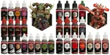A detailed image showcases a vibrant miniature of a Chaos Space Marine, prominently featuring green skin, horns, and intricate armor details, holding a weapon. Surrounding the miniature are various paint bottles labeled with names like "Elder Flower," "Military Shade," and "Gun Metal," organized in two groups. The colors range from earthy tones to metallics, emphasizing the curated selection for painting Chaos forces in Warhammer 40,000.