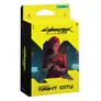 A brightly colored packaging for the Cyberpunk Trading Card Game features a striking illustration of a character with long red hair, holding a gun, set against a backdrop of a futuristic urban environment. The box is predominantly yellow with bold black text that reads "Cyberpunk TCG" and "WELCOME TO NIGHT CITY." The design emphasizes a sleek, modern aesthetic, reflecting the game's cyberpunk theme.
