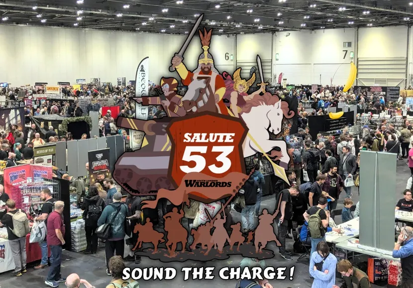 A bustling scene from SALUTE 53, Europe's largest independent wargames show, held at the London ExCel. The image captures a crowded exhibition hall filled with attendees exploring various vendor stands, with a prominent graphic overlay featuring the event's logo and artwork of a knight, a horse, and other characters. The atmosphere is lively, showcasing the excitement and engagement of the wargaming community.