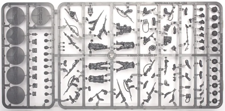 A sprue featuring multi-part figures of British and Canadian winter infantry, showcasing six distinct soldier poses, all equipped with various winter gear. The sprue includes an assortment of weapons such as rifles, machine guns, SMGs, and specialist items like sniper rifles, mortars, and flamethrowers, along with engineering tools like shovels and mine sweepers. The figures are intricately detailed, emphasizing their readiness for winter conditions.
