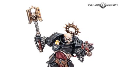 A Black Templars Execrator stands in a dynamic pose, wielding a large, ornate power hammer in one hand and a pyre pistol in the other. The figure is clad in black armor adorned with gold and silver details, including a skull motif on the helmet and a purity seal on the chest. The base features a grassy terrain with scattered skulls, enhancing the grim aesthetic typical of the Warhammer 40,000 universe.