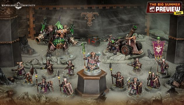 A detailed display of the new Zharrdron army features various miniatures set against a dark, industrial backdrop. In the center, a prominent War Despot stands on a pedestal, clad in imposing armor and wielding a staff, surrounded by Infernal Cohorts holding spears. To the left, a large, menacing Dominator Engine looms, while a mortar-like Tormentor Bombard is positioned on the right, showcasing the army's dark and chaotic aesthetic.