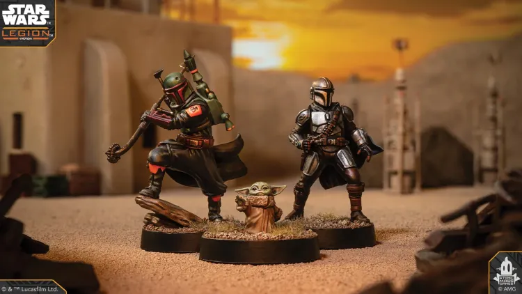 A detailed miniature of Boba Fett stands in a dynamic pose, wielding a weapon, with his iconic green and red armor featuring a distinctive emblem on his shoulder. Beside him, Grogu, also known as 