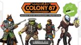 Four detailed miniatures from the "Colony 87: Wave Five" series are displayed against a bold graphic background featuring the campaign title. The figures include a green-skinned character in a dark outfit with a hat and a staff, a yellow-skinned figure in a blue and brown uniform holding a device, a character in a brown and blue outfit, and a figure in a white and brown suit with a distinctive helmet. The Crooked Dice logo is prominently featured at the bottom, emphasizing the game's design studio.