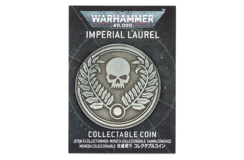A collectible coin featuring a prominent skull surrounded by laurel leaves, set against a dark, starry background. The coin is labeled "IMPERIAL LAUREL" at the top and "COLLECTABLE COIN" at the bottom, with additional text in multiple languages. The design reflects the Warhammer 40,000 theme, emphasizing its collectible nature.
