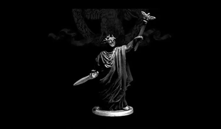 A 28mm scale miniature of Caesar Imperator stands prominently against a dark background. The figure is cast in white metal, showcasing intricate details such as a laurel crown and flowing robes. In one hand, he holds a sword, while the other is raised, delicately supporting a butterfly, symbolizing peace or transformation. The base is circular, providing stability to the figure, which is sculpted with a sense of grandeur and historical significance.