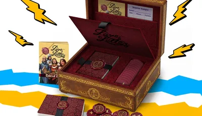Open wooden Love Letter box with cards, tokens, and rulebook, surrounded by lightning bolts and waves.