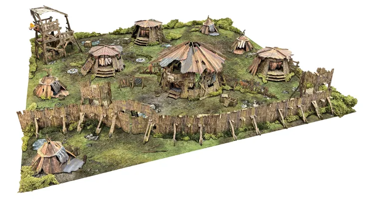 A detailed tabletop terrain scene depicting a primitive encampment, featuring several round huts with thatched roofs, surrounded by a makeshift wooden barricade. The terrain includes a large roundhouse, smaller huts, and various barrels, with patches of greenery and a dirt ground. The overall design reflects a rugged, barbarian aesthetic suitable for fantasy gaming.